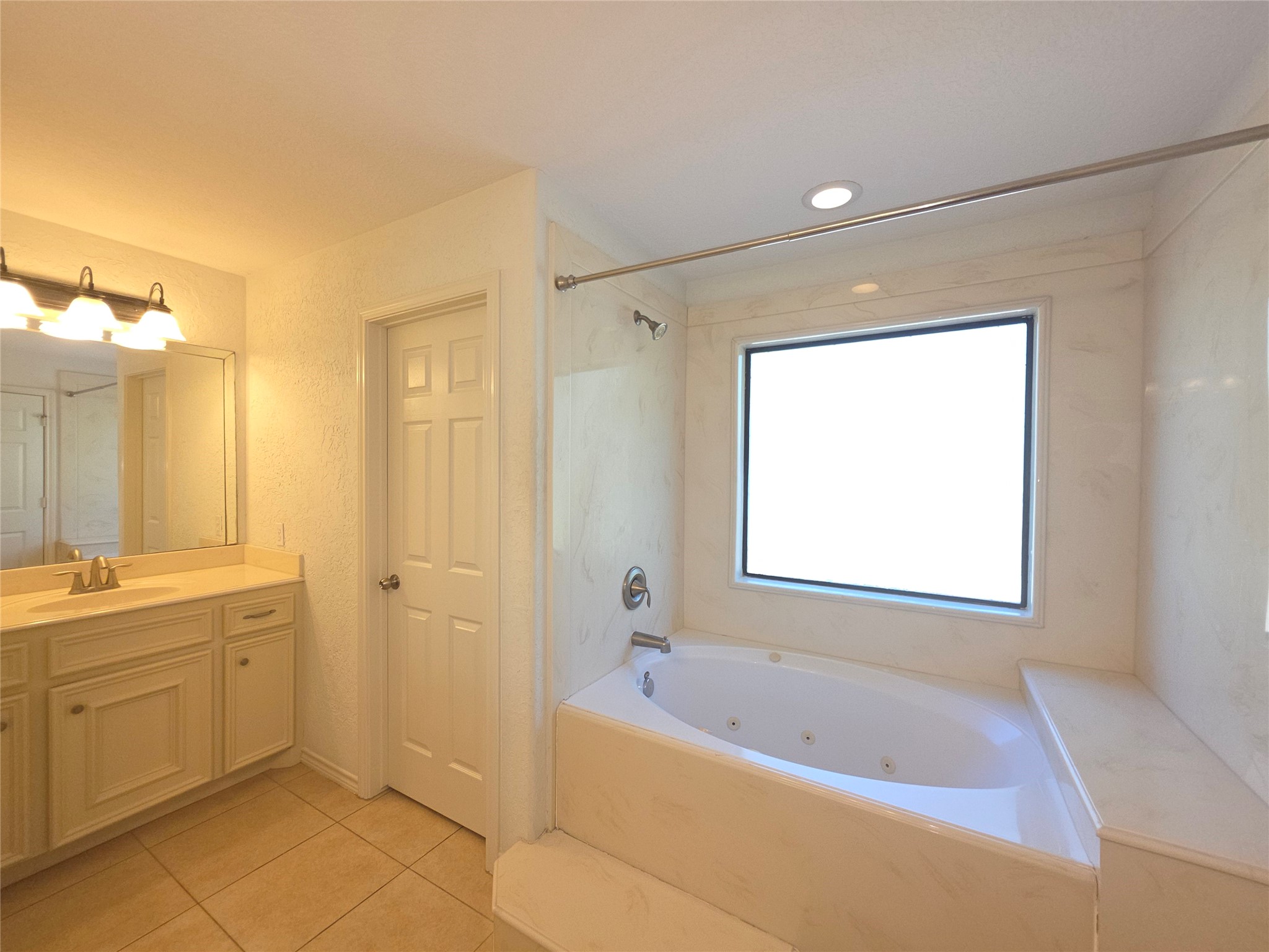 1898 Longmire Road, Unit 8 Conroe, TX 77304 - Photo 11 of 17 a bathroom with a bathtub a sink and a shower