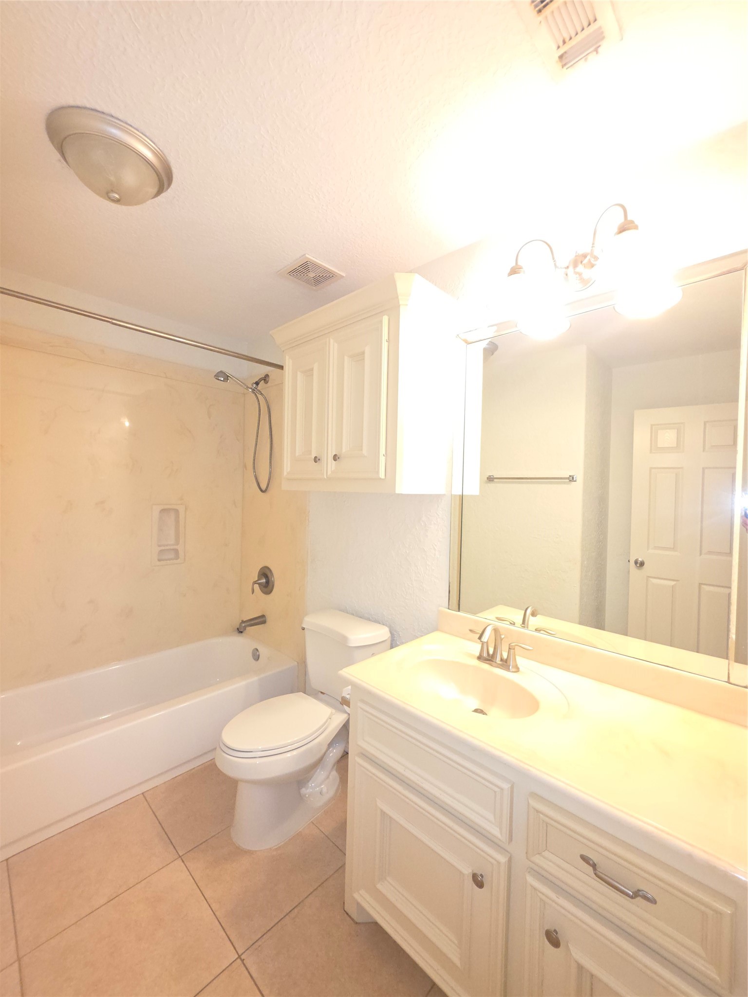 1898 Longmire Road, Unit 8 Conroe, TX 77304 - Photo 15 of 17 a bathroom with a granite countertop sink a toilet and a bathtub