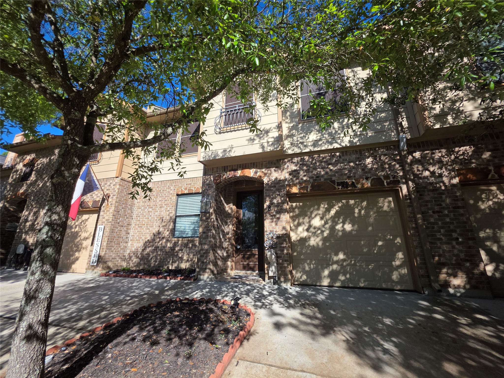 1898 Longmire Road, Unit 8 Conroe, TX 77304 - Photo 2 of 17 a view of a house with a tree