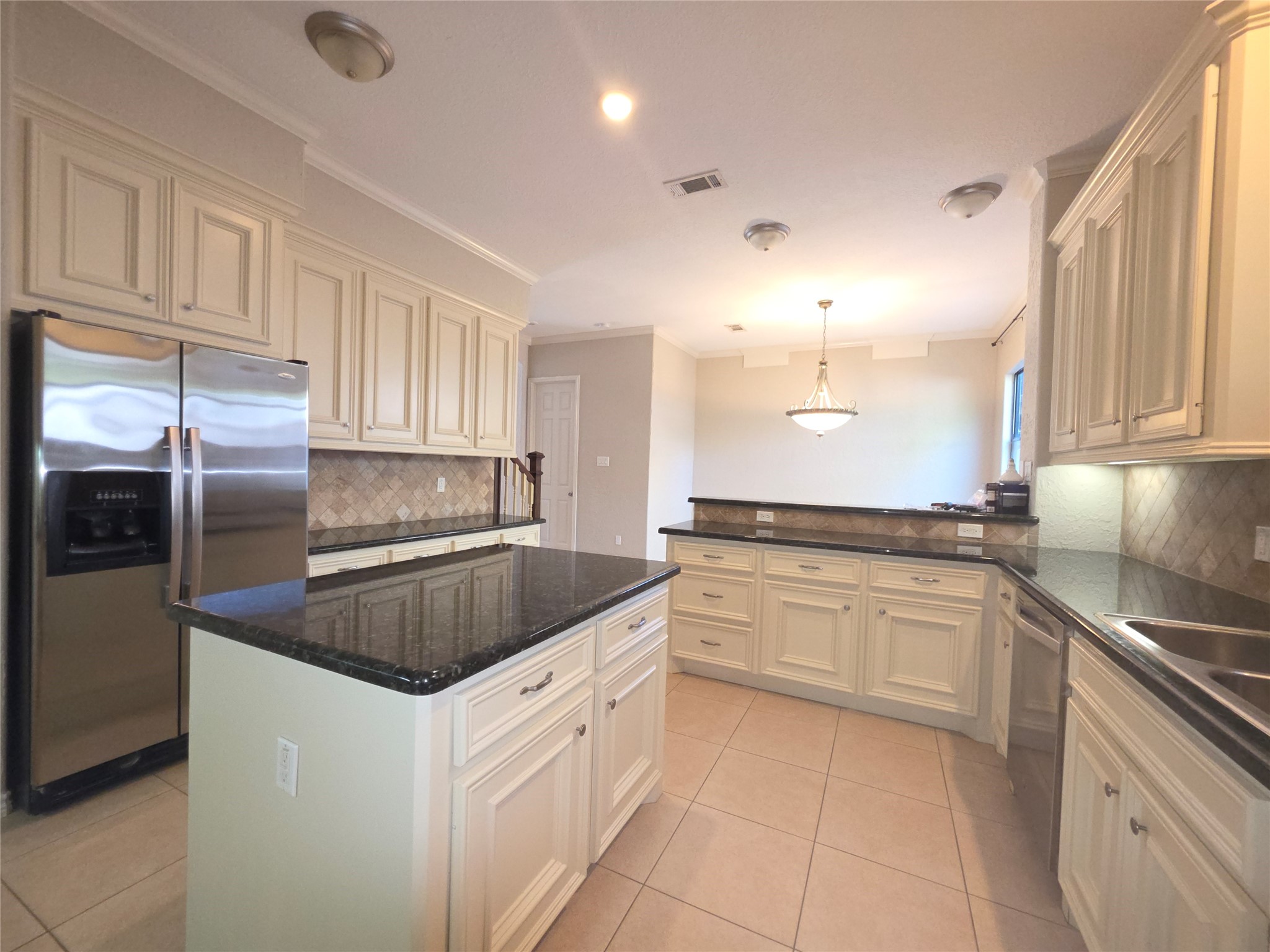 1898 Longmire Road, Unit 8 Conroe, TX 77304 - Photo 4 of 17 a kitchen with granite countertop a sink and stainless steel appliances