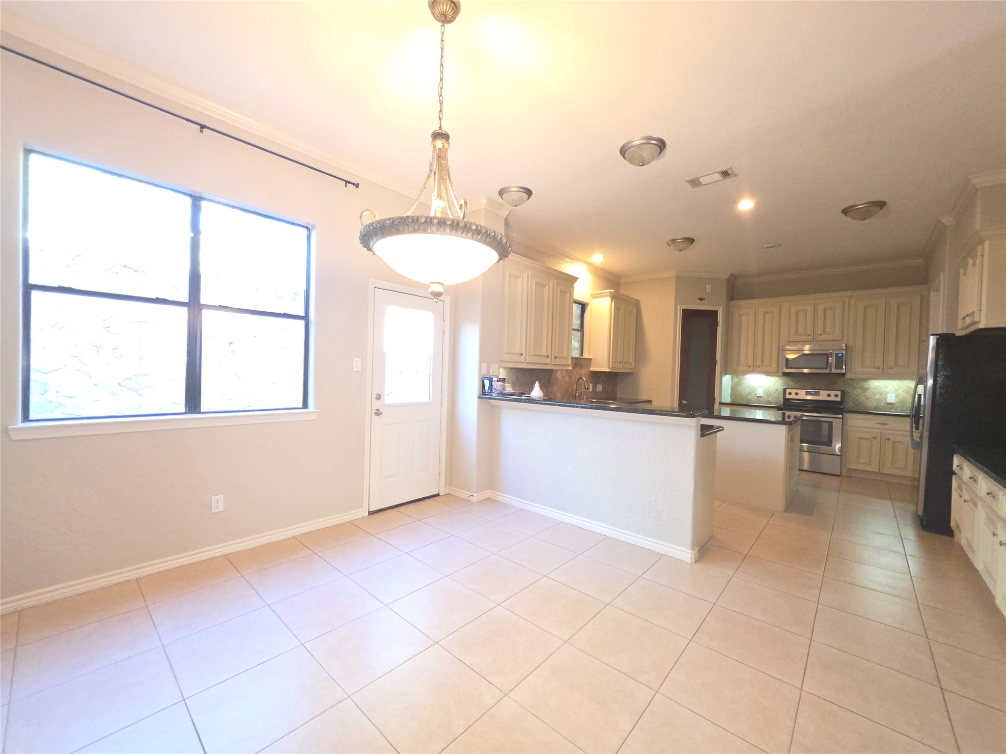 1898 Longmire Road, Unit 8 Conroe, TX 77304 - Photo 5 of 17 a view of kitchen with refrigerator and window