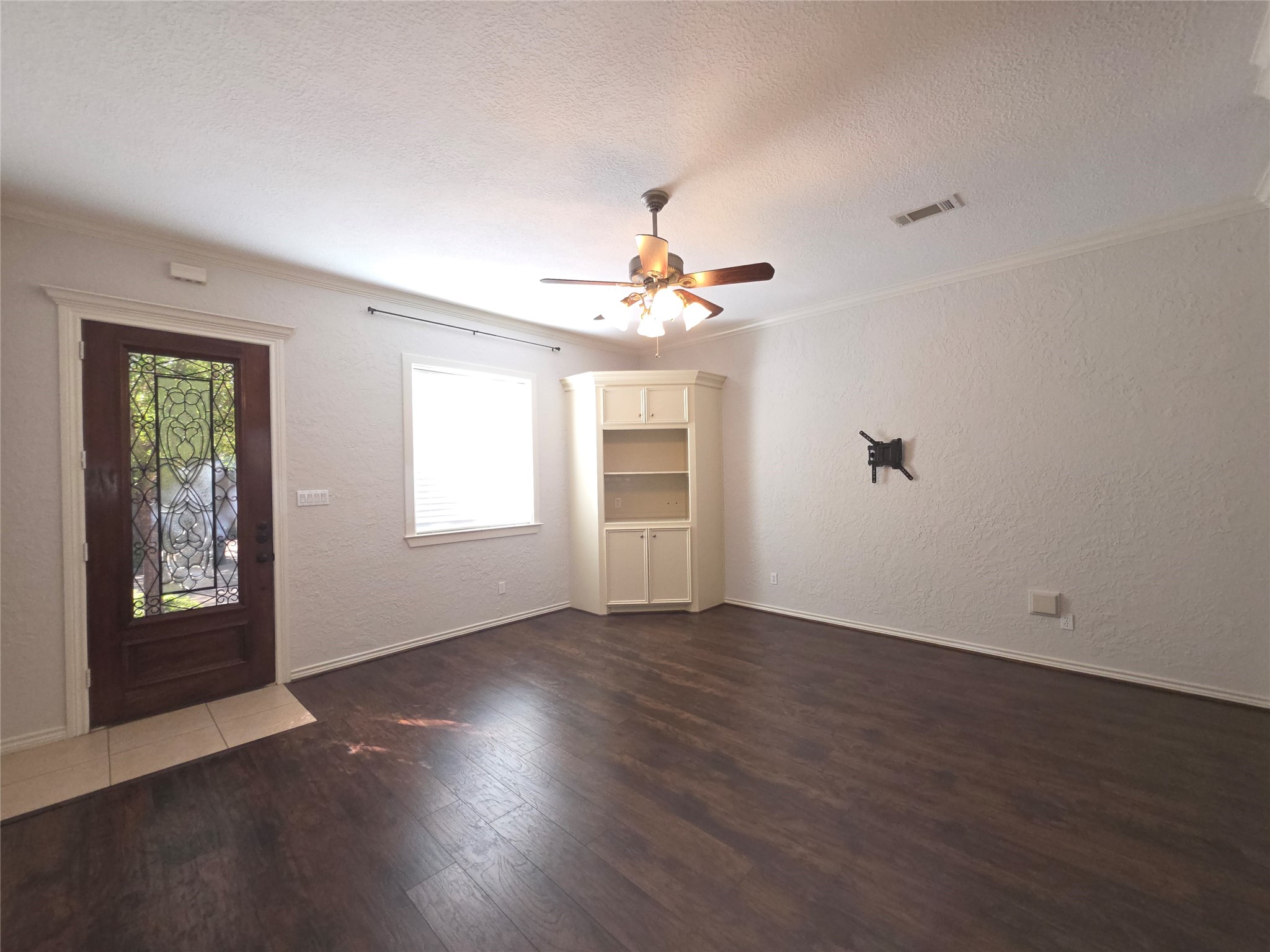 1898 Longmire Road, Unit 8 Conroe, TX 77304 - Photo 7 of 17 a view of an empty room with window and wooden floor