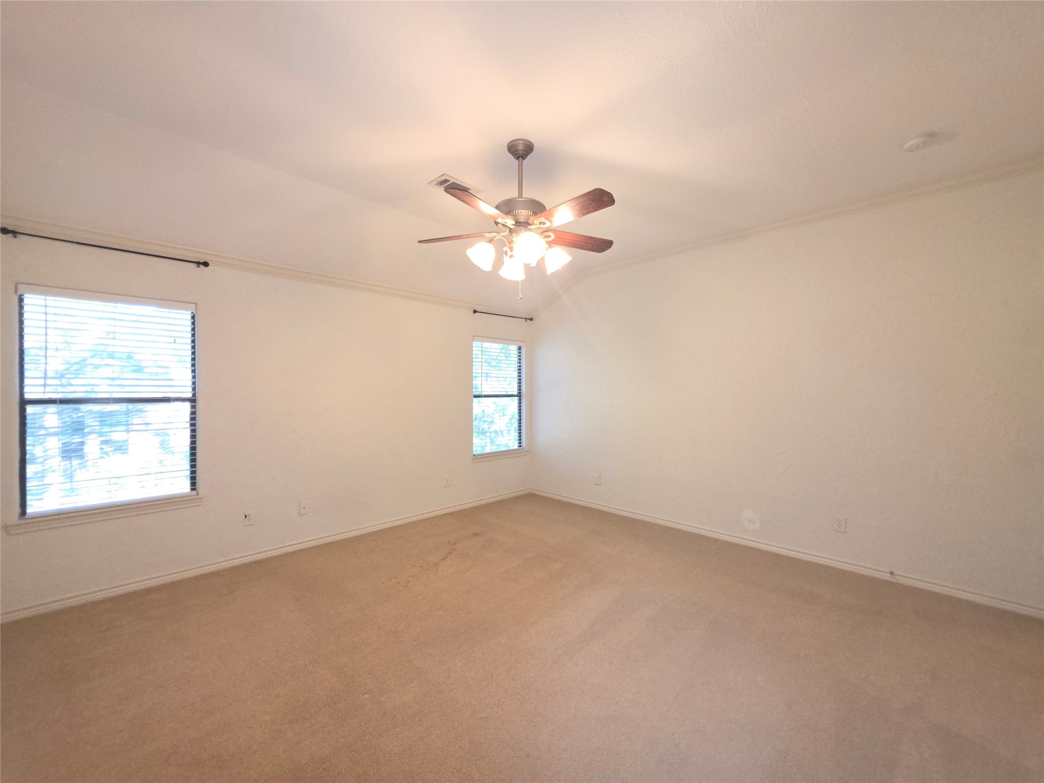 1898 Longmire Road, Unit 8 Conroe, TX 77304 - Photo 9 of 17 an empty room with windows and chandelier fan