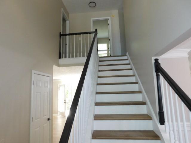1834 Stephens Pond View Loganville, GA 30052 - Photo 13 of 25 a view of staircase with wooden floor and white walls