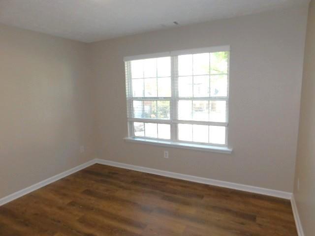 1834 Stephens Pond View Loganville, GA 30052 - Photo 14 of 25 an empty room with wooden floor and windows