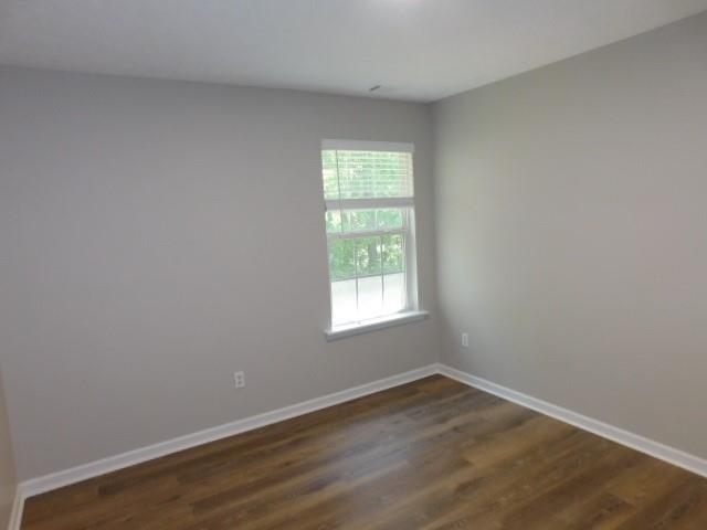 1834 Stephens Pond View Loganville, GA 30052 - Photo 16 of 25 an empty room with wooden floor and windows