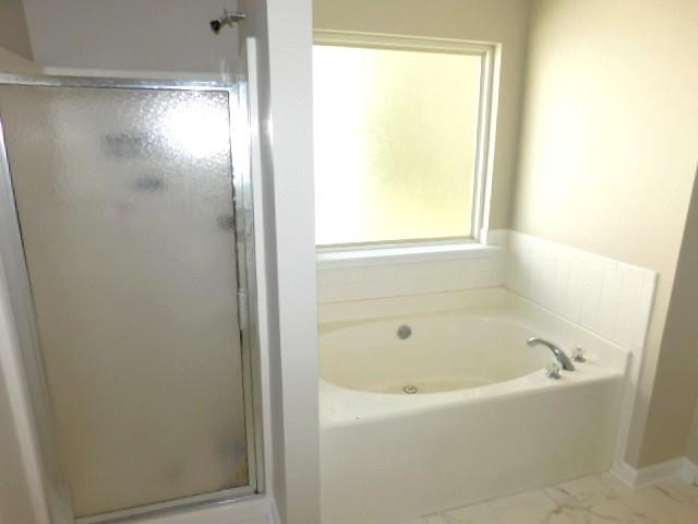 1834 Stephens Pond View Loganville, GA 30052 - Photo 24 of 25 a white bath tub sitting next to a window