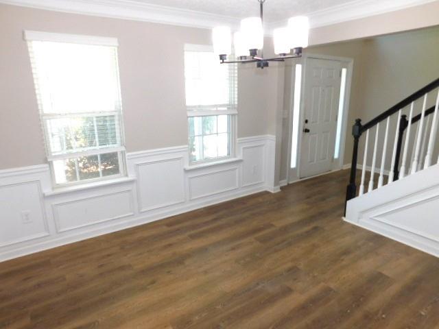 1834 Stephens Pond View Loganville, GA 30052 - Photo 3 of 25 an empty room with wooden floor cabinet and windows