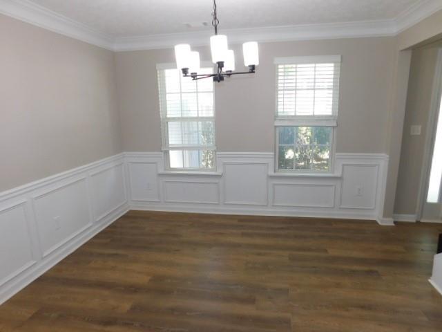 1834 Stephens Pond View Loganville, GA 30052 - Photo 4 of 25 a view of an empty room with wooden floor and a window