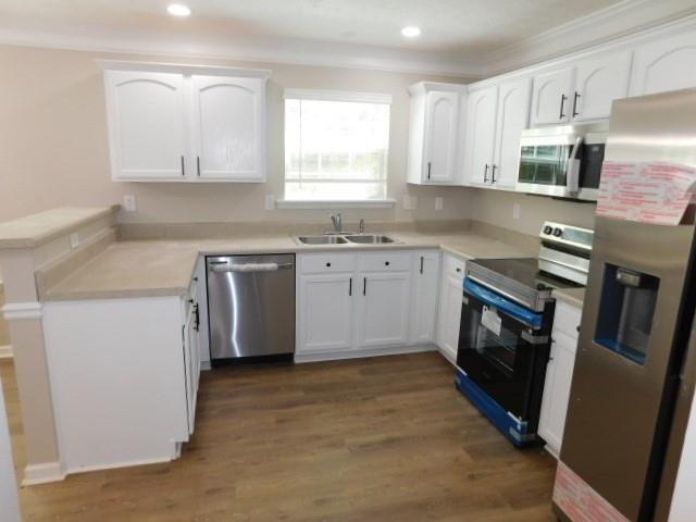 1834 Stephens Pond View Loganville, GA 30052 - Photo 5 of 25 a kitchen with stainless steel appliances granite countertop a sink stove and refrigerator