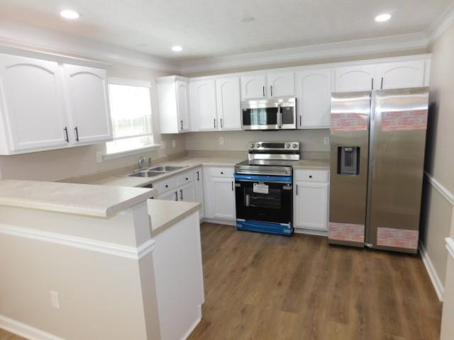 1834 Stephens Pond View Loganville, GA 30052 - Photo 7 of 25 a kitchen with stainless steel appliances granite countertop a stove a sink and a refrigerator