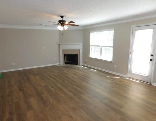 1834 Stephens Pond View Loganville, GA 30052 - Photo 10 of 25 an empty room with wooden floor chandelier fan and windows