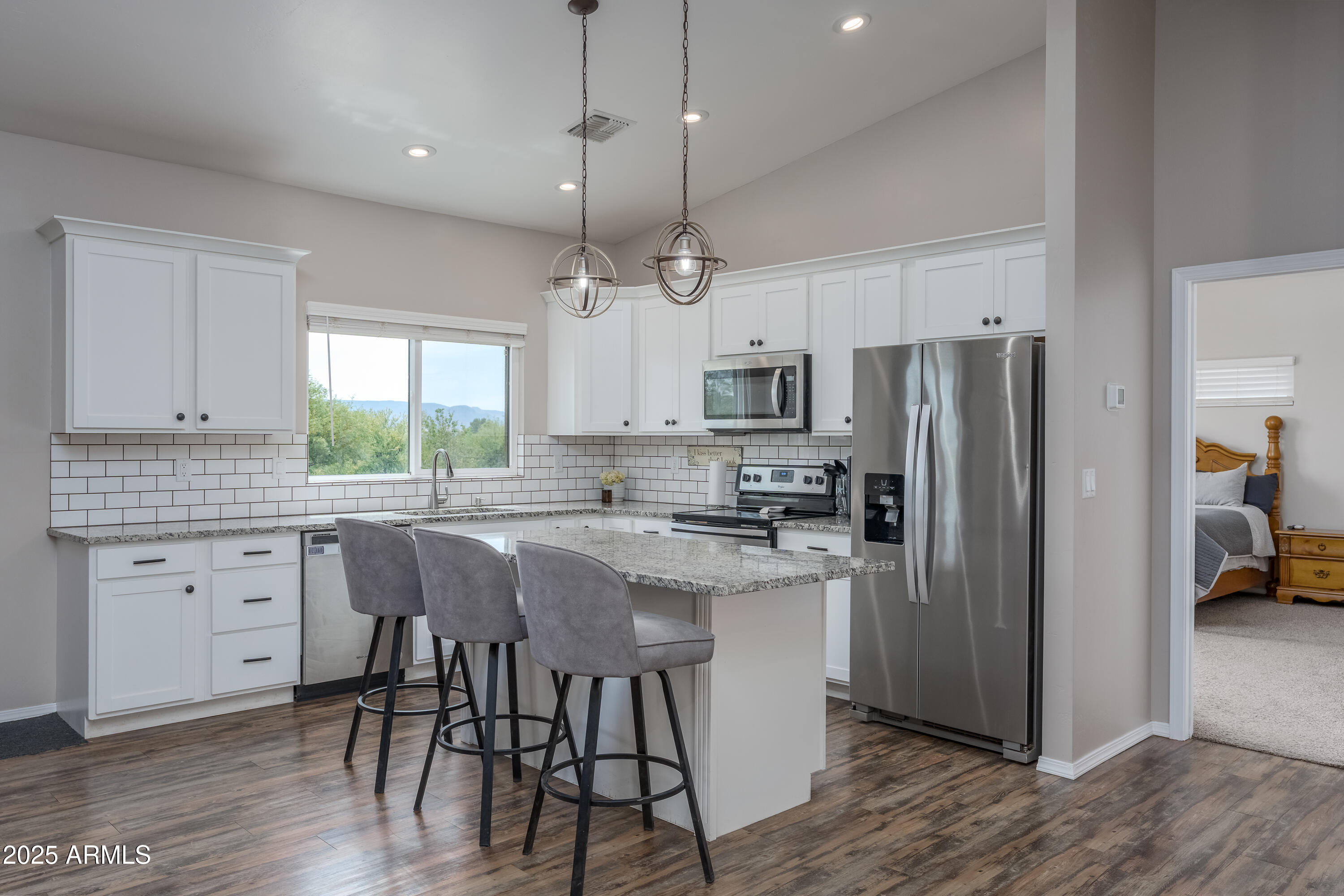 955 West Copperhead Road Camp Verde, AZ 86322 - Photo 23 of 35 a kitchen with kitchen island granite countertop a center island a sink stainless steel appliances and cabinets