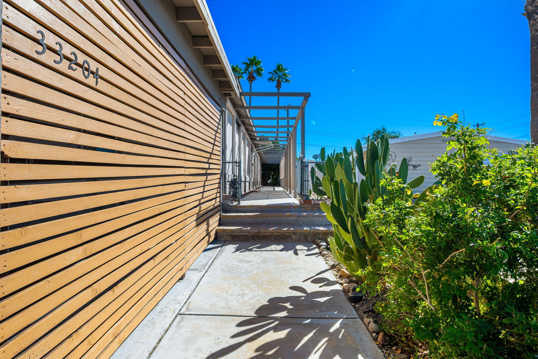 33204 Laredo Circle Thousand Palms, CA 92276 - Photo 11 of 62 a view of a pathway with a house in the background