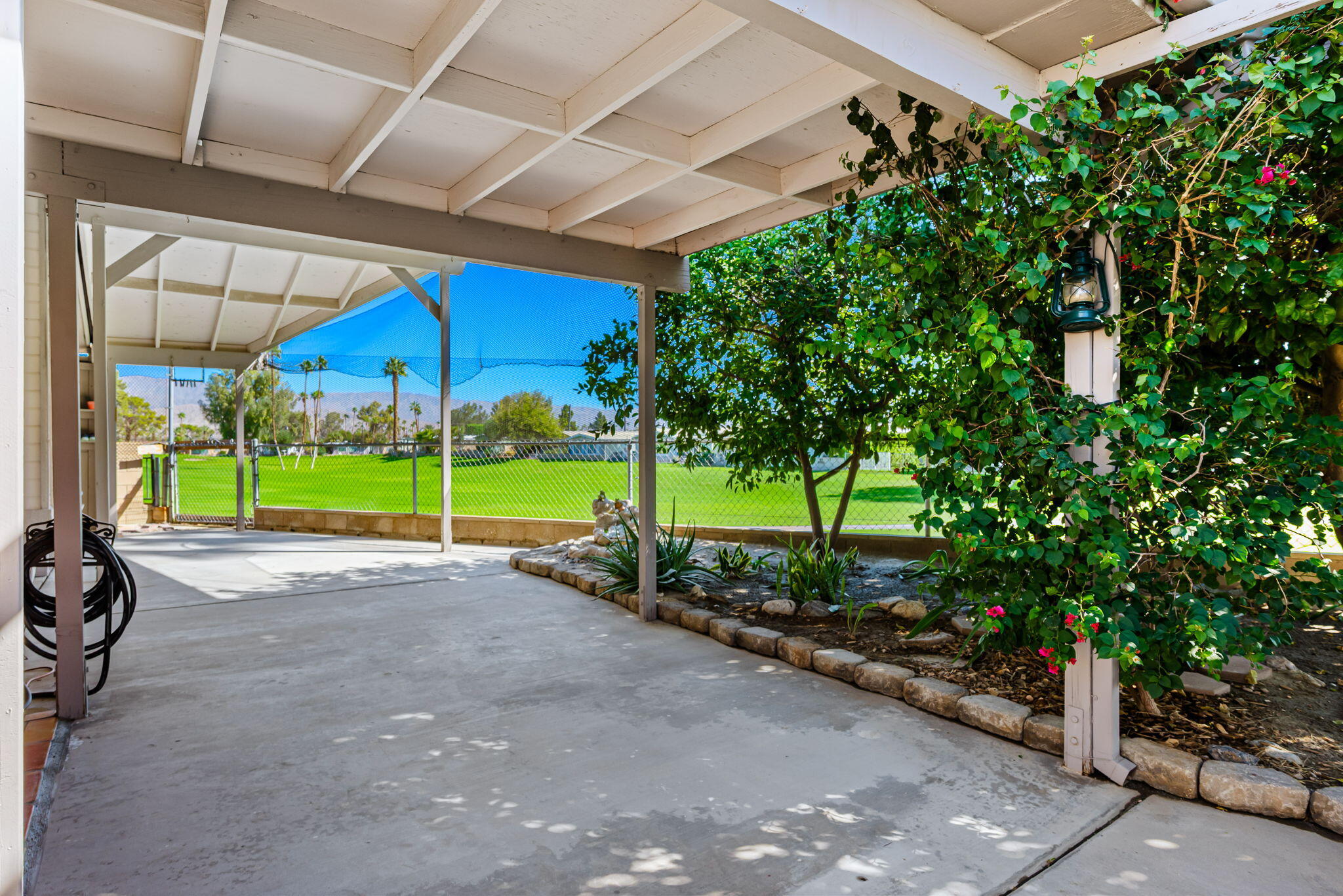 33204 Laredo Circle Thousand Palms, CA 92276 - Photo 14 of 62 a view of a road with plants and large trees