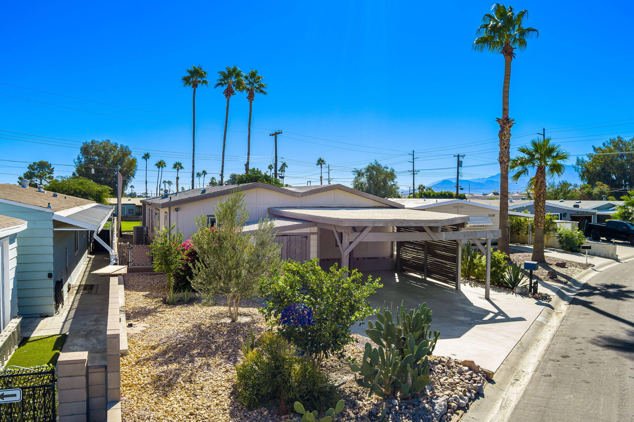 33204 Laredo Circle Thousand Palms, CA 92276 - Photo 2 of 62 a view of a patio with a table and chairs under an umbrella with potted plants