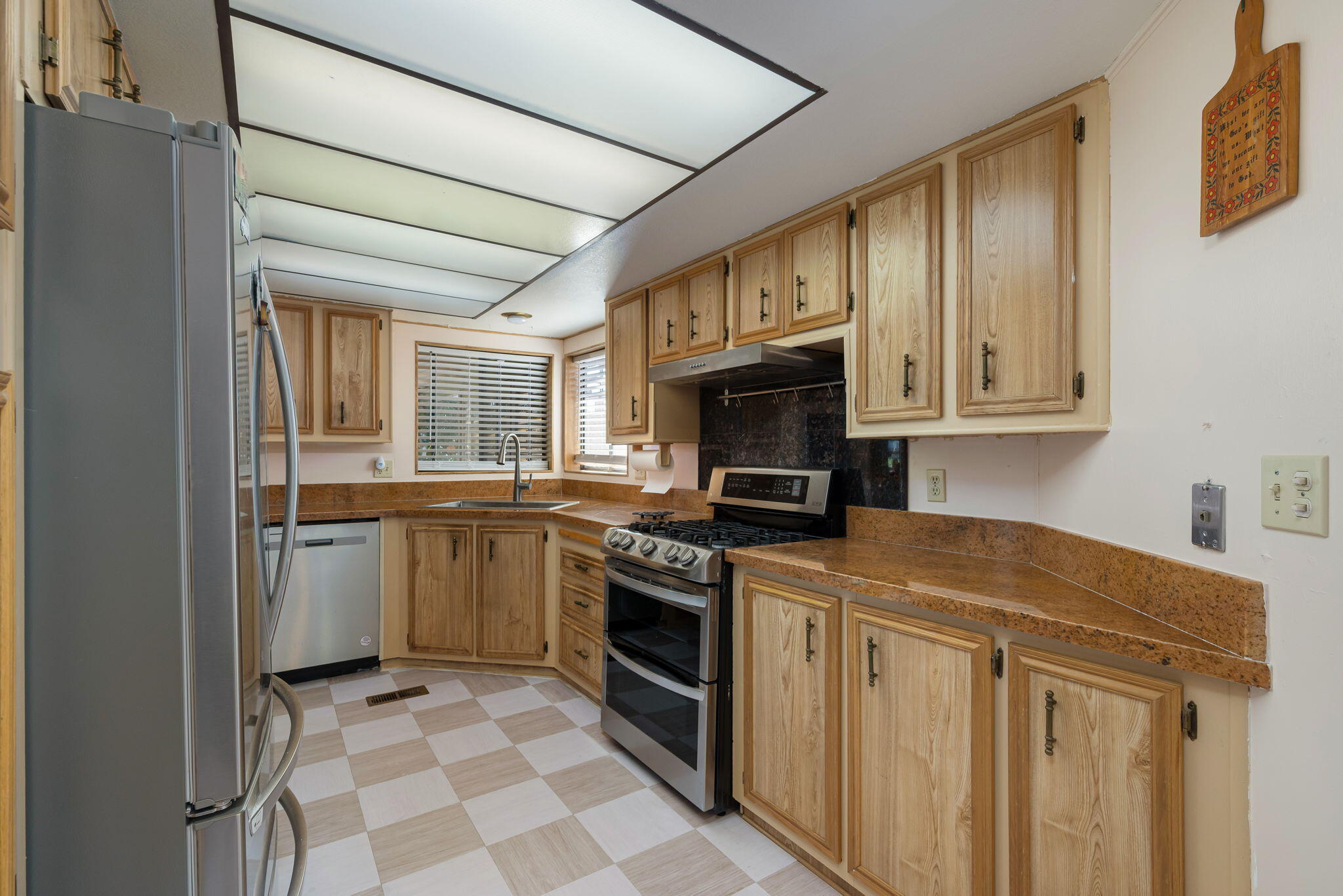 33204 Laredo Circle Thousand Palms, CA 92276 - Photo 30 of 62 a kitchen with a stove top oven sink and cabinets