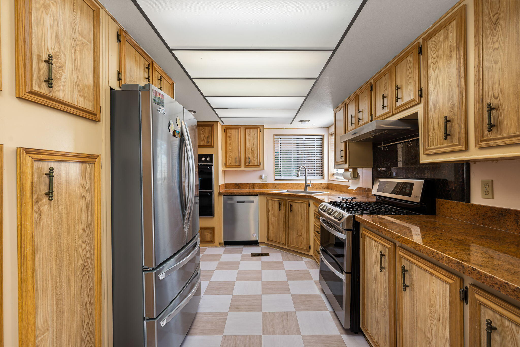 33204 Laredo Circle Thousand Palms, CA 92276 - Photo 31 of 62 a kitchen with stainless steel appliances granite countertop a refrigerator a stove top oven and sink