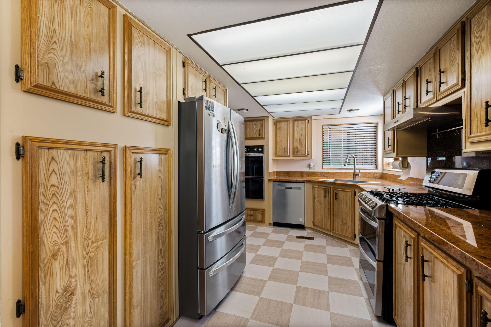 33204 Laredo Circle Thousand Palms, CA 92276 - Photo 32 of 62 a kitchen with stainless steel appliances granite countertop a refrigerator and a stove top oven