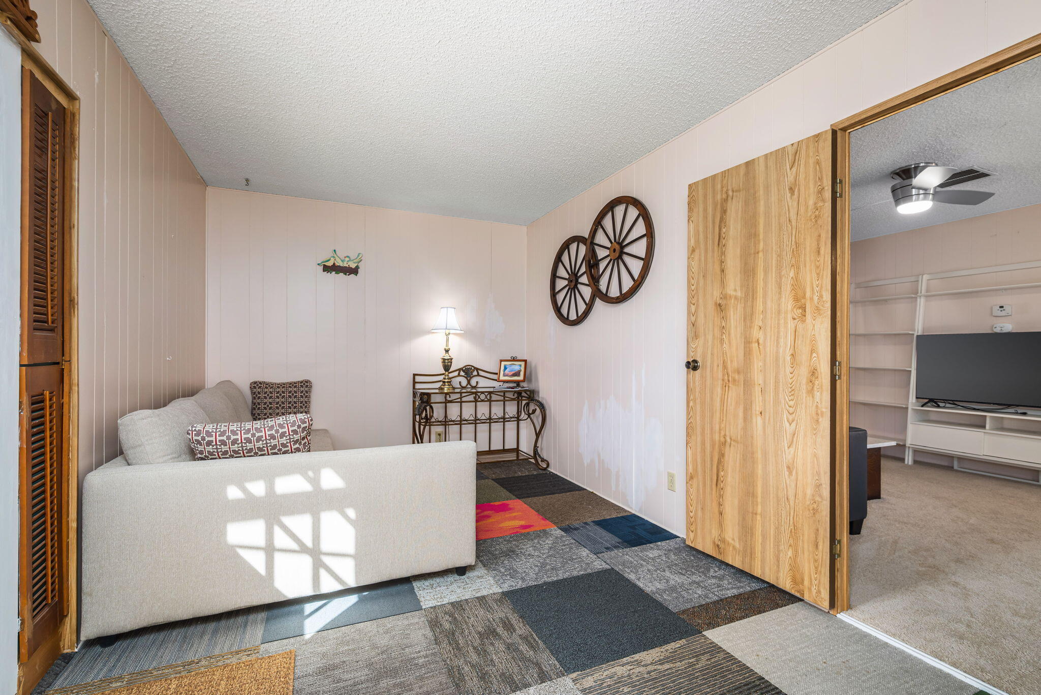 33204 Laredo Circle Thousand Palms, CA 92276 - Photo 40 of 62 a living room with a couch and a table with wooden floor