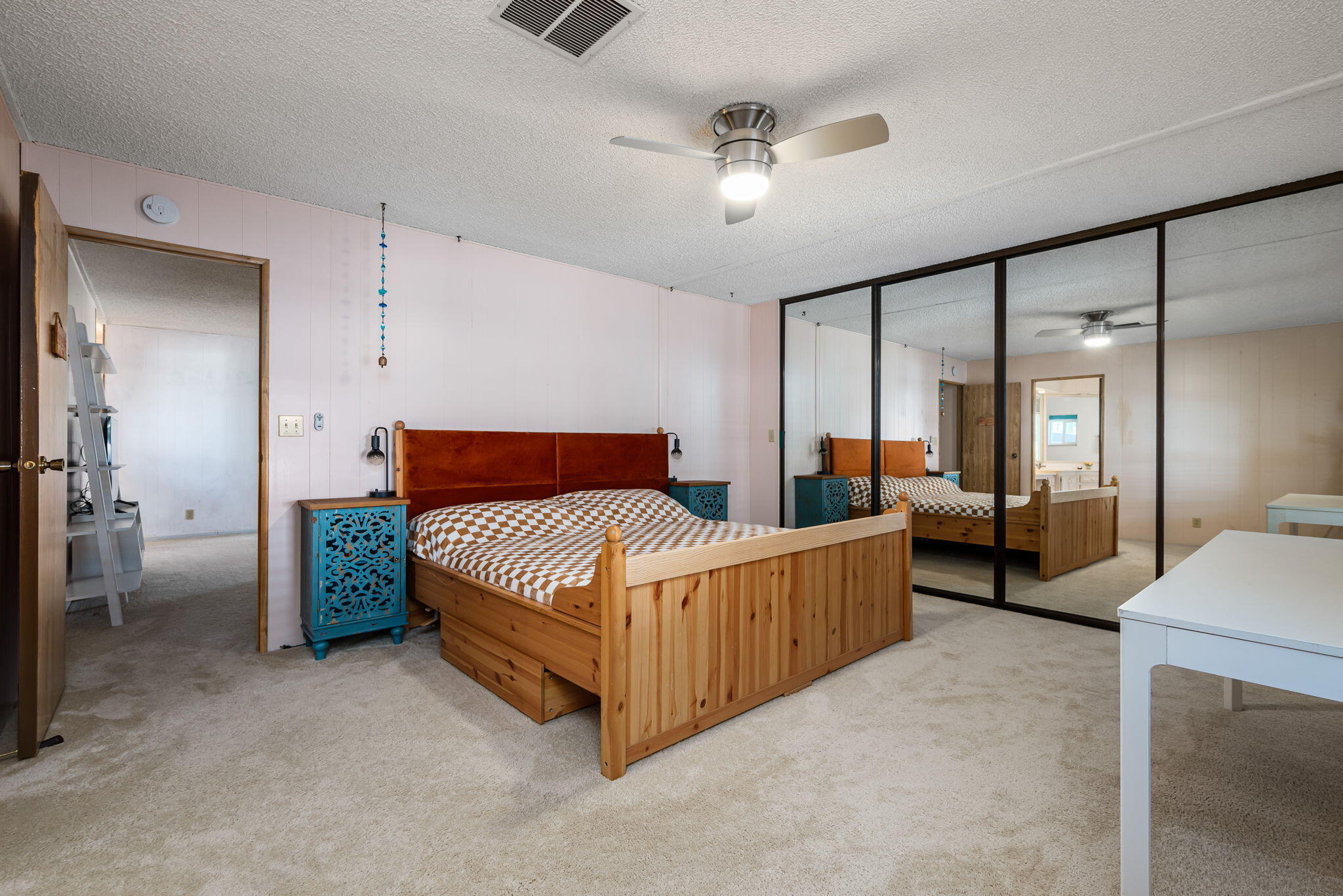 33204 Laredo Circle Thousand Palms, CA 92276 - Photo 42 of 62 a bedroom with a bed and a chandelier