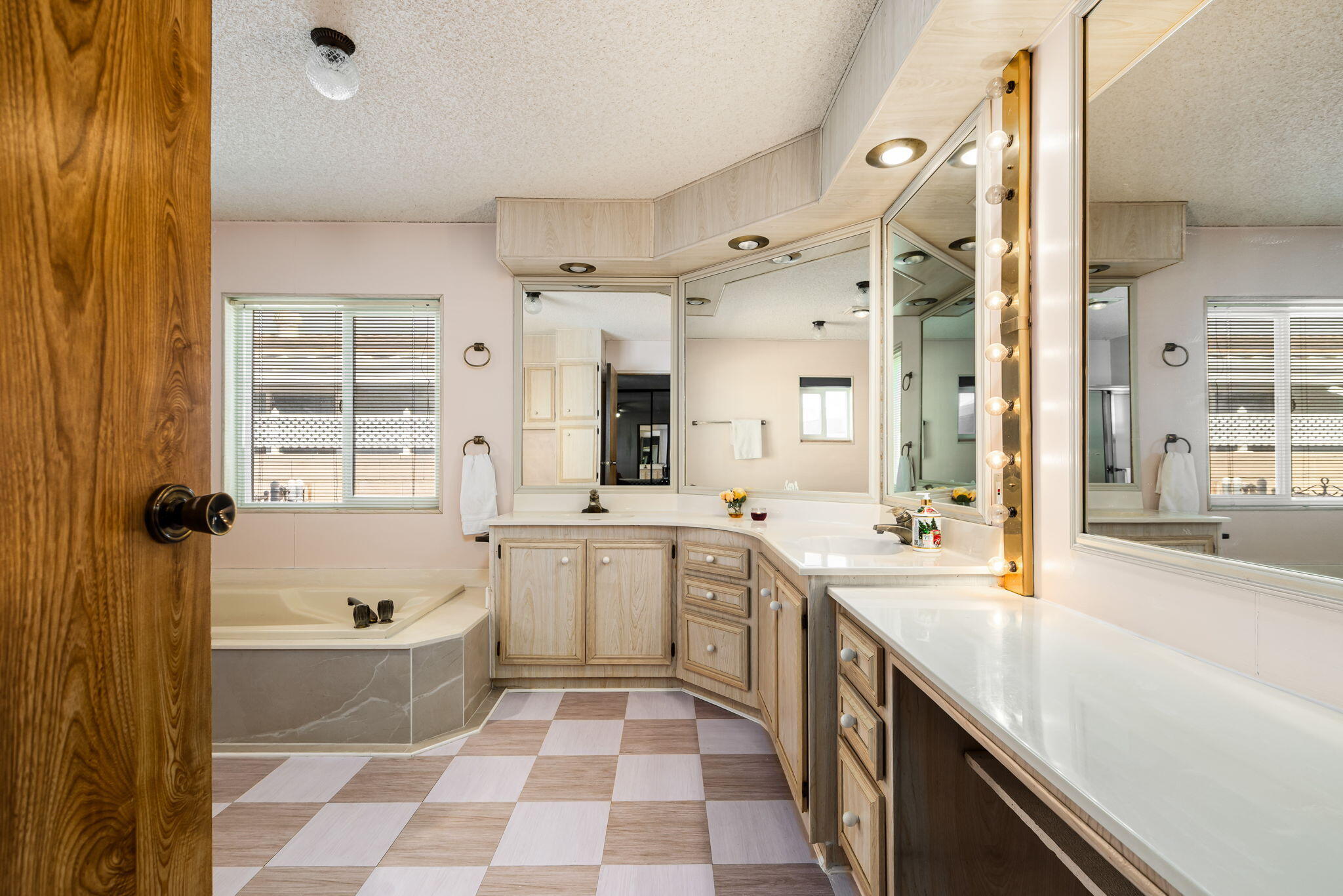 33204 Laredo Circle Thousand Palms, CA 92276 - Photo 44 of 62 a spacious bathroom with a double vanity sink a large mirror and a bathtub