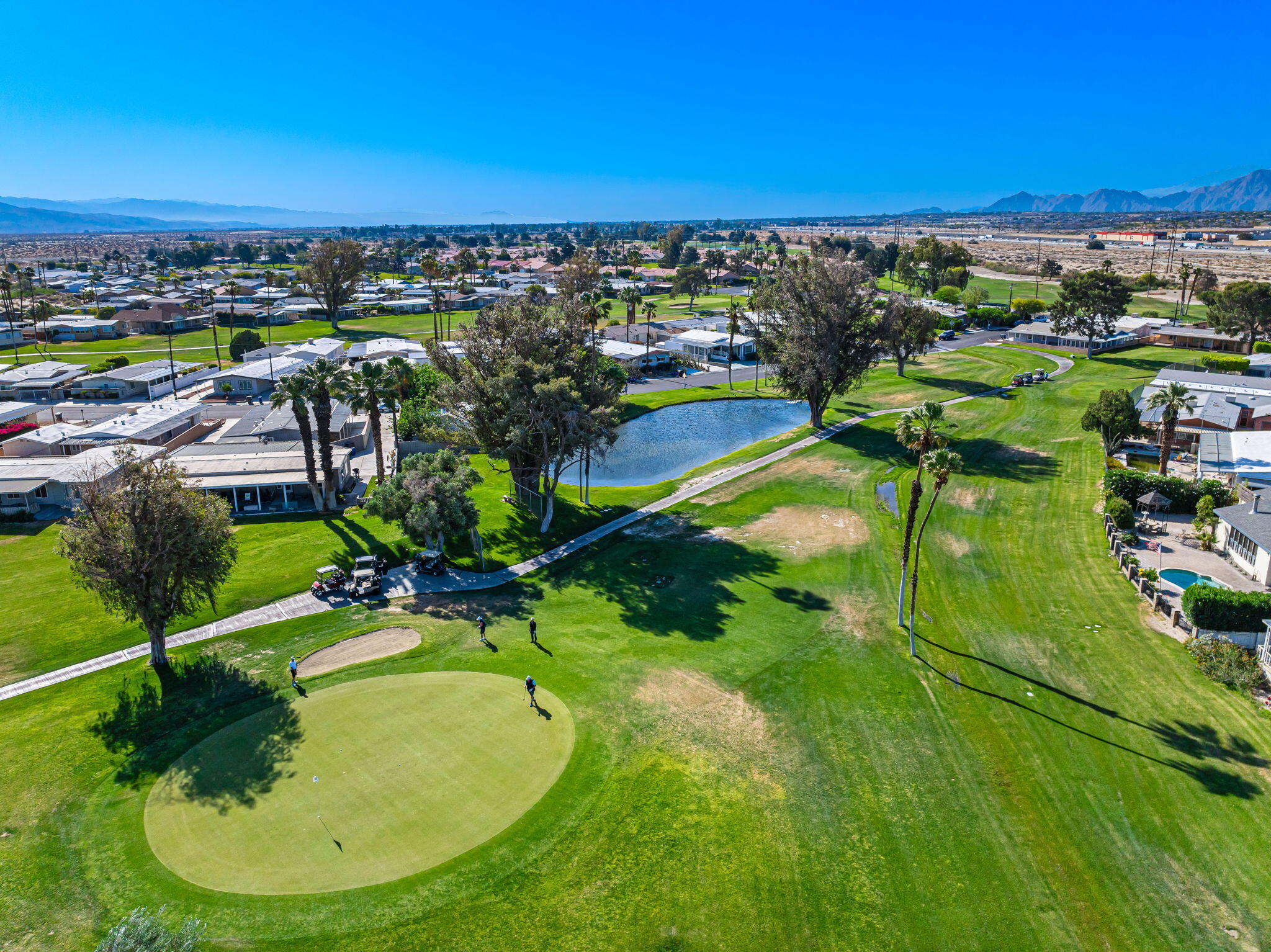 33204 Laredo Circle Thousand Palms, CA 92276 - Photo 62 of 62 a view of a swimming pool with a yard and mountain view