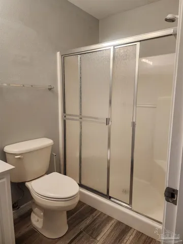 a bathroom with a toilet and a shower