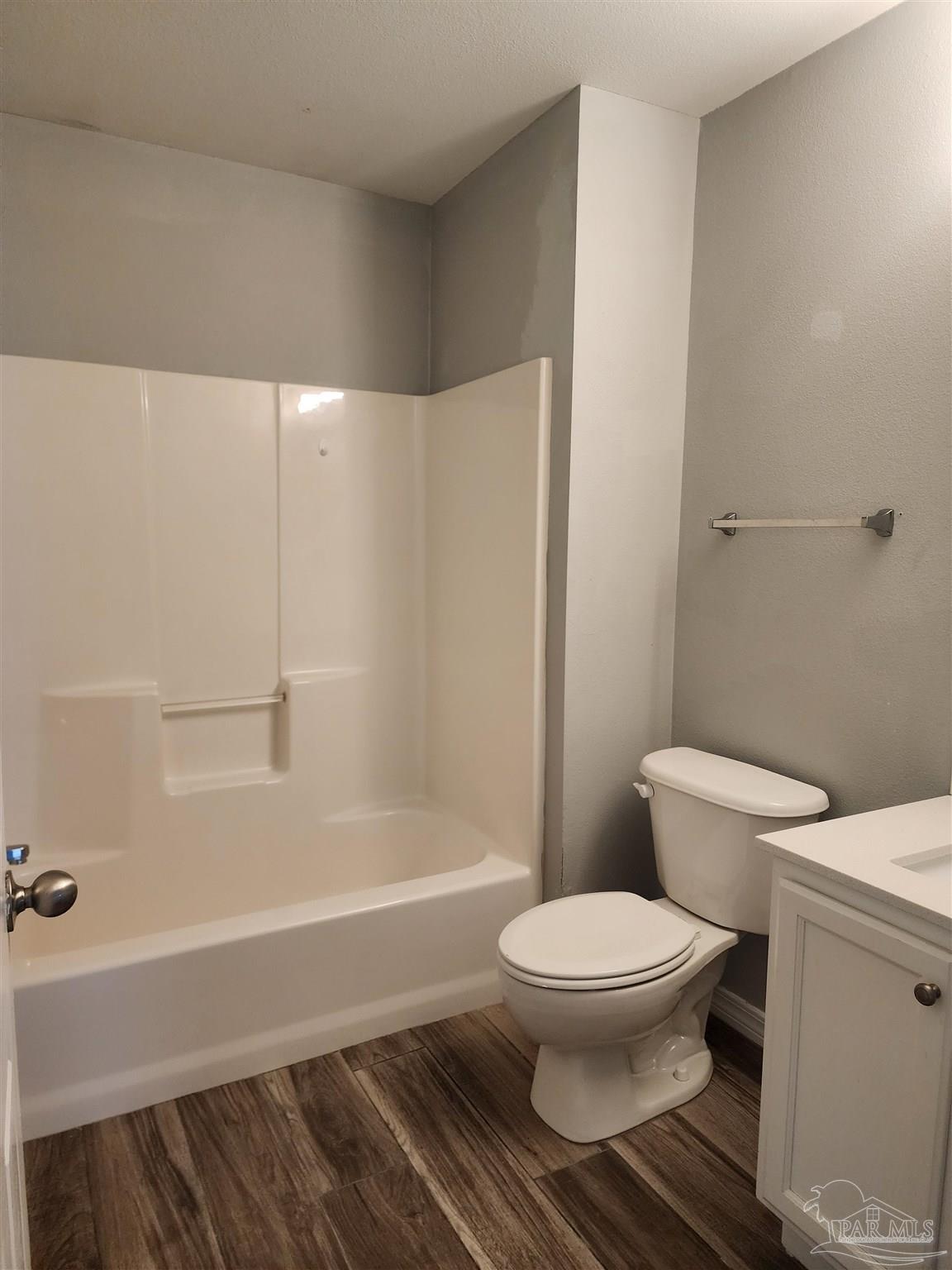 7447 Harvest Village Court Navarre, FL 32566 - Photo 20 of 27 a white toilet sitting next to a bath tub