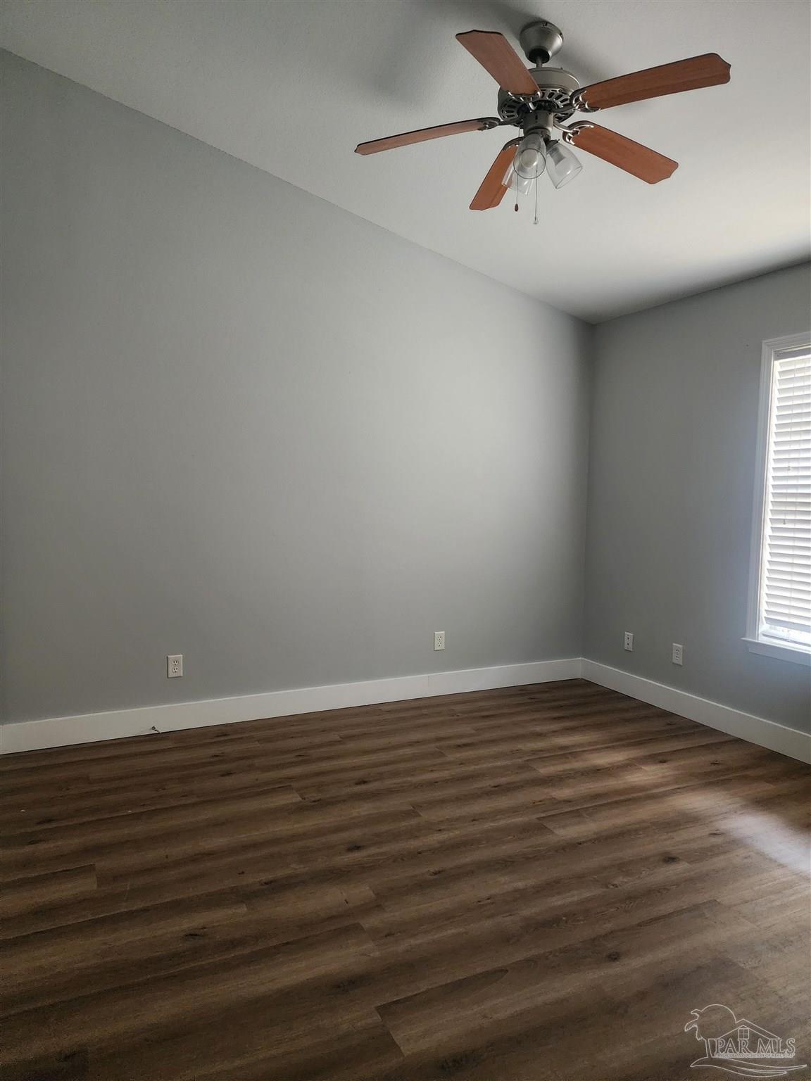 7447 Harvest Village Court Navarre, FL 32566 - Photo 2 of 27 wooden floor in an empty room