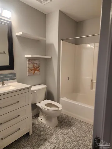a bathroom with a toilet sink and shower