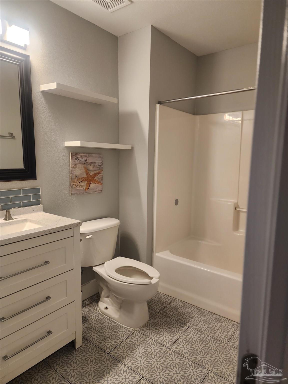 7447 Harvest Village Court Navarre, FL 32566 - Photo 5 of 27 a bathroom with a toilet sink and shower