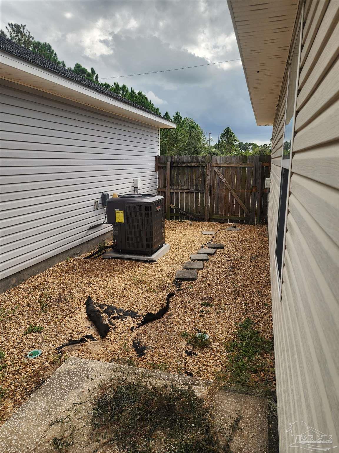 7447 Harvest Village Court Navarre, FL 32566 - Photo 8 of 27 a backyard of a house