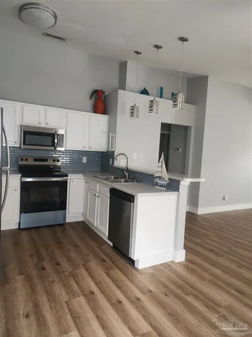 a kitchen with granite countertop a sink and a stove top oven