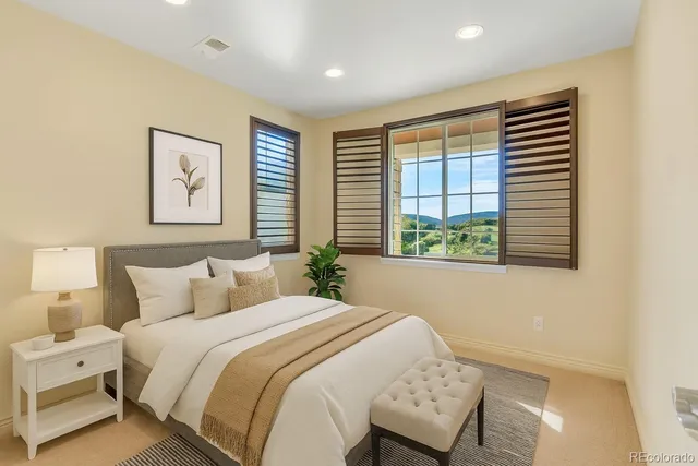 a bedroom with a large bed and a window