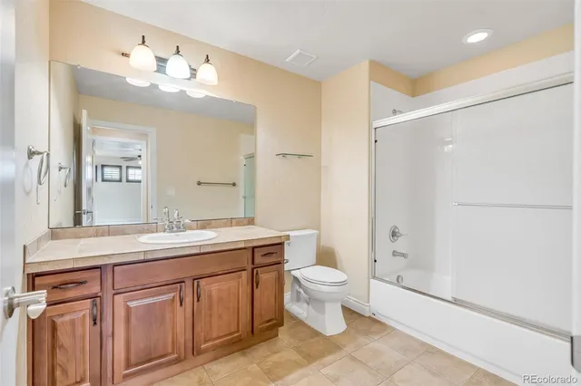 a bathroom with a double vanity sink mirror and toilet