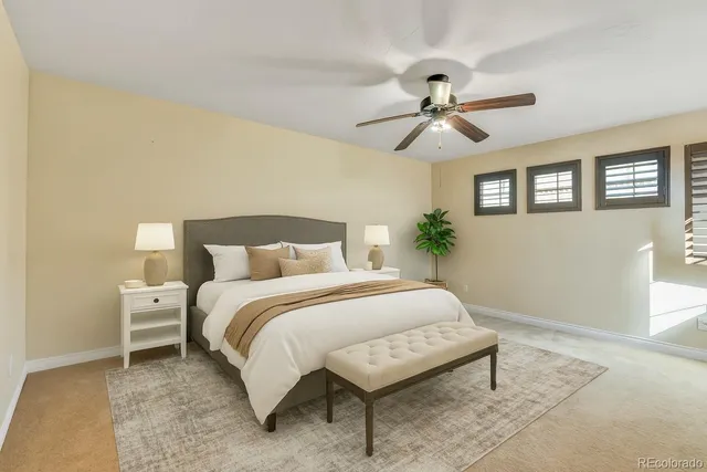 a spacious bedroom with a bed and a chandelier