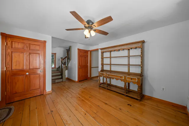 a view of workspace with wooden floor and ceiling fan