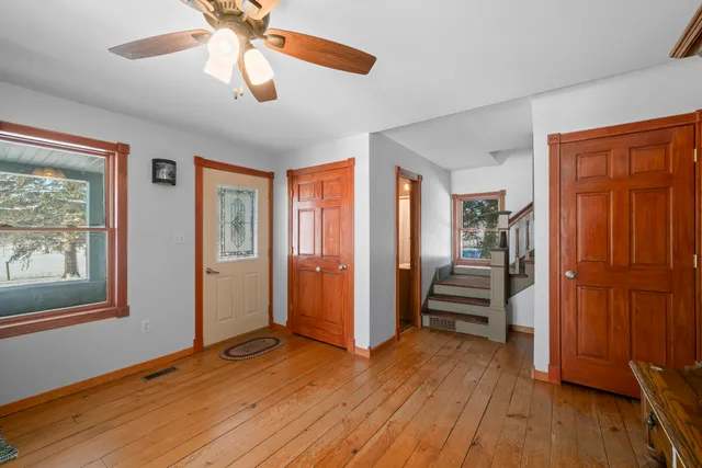 wooden floor in an empty room with a window