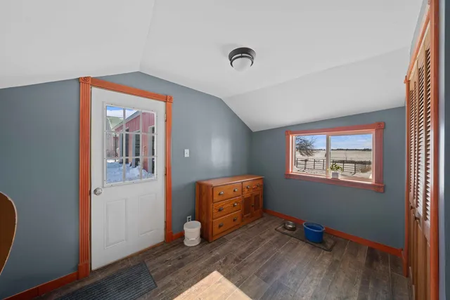 a room with chair and wooden floor