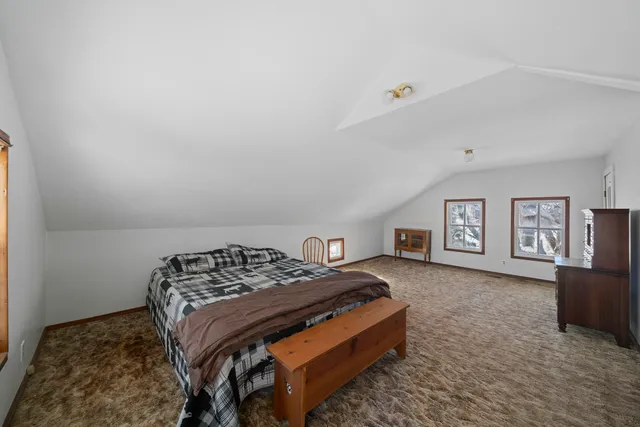 a bedroom with a bed and dresser