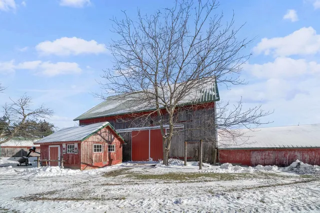 a view of a house with a yard covered in snow