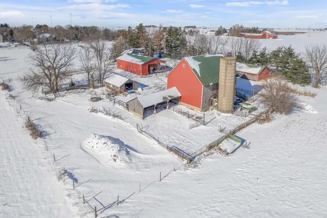 an aerial view of a house with a yard and ocean view
