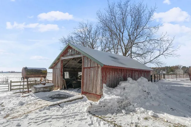 a view of a house with a yard covered in snow