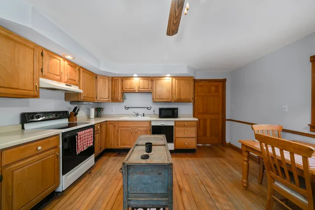 a kitchen with stainless steel appliances a stove a sink dishwasher and a refrigerator