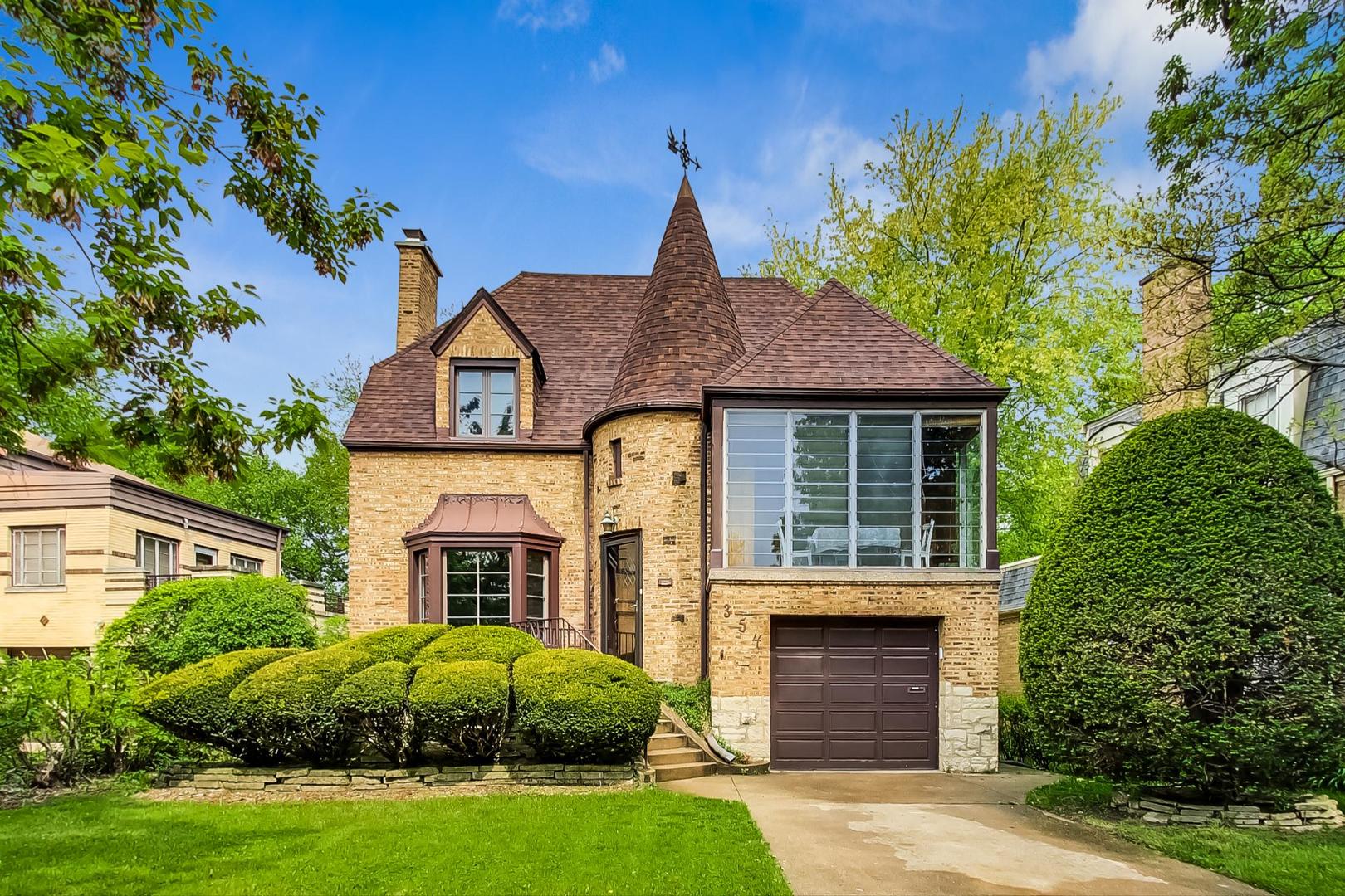 354 Longcommon Road Riverside, IL 60546 - Photo 1 of 37 a front view of a house with a garden