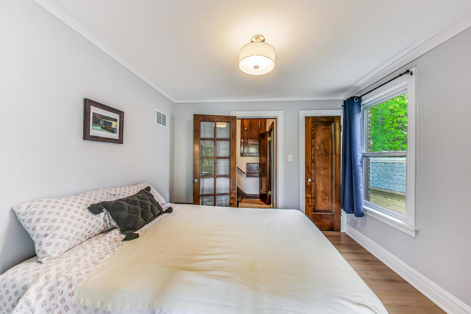 354 Longcommon Road Riverside, IL 60546 - Photo 13 of 37 a bedroom with a large bed and a large window