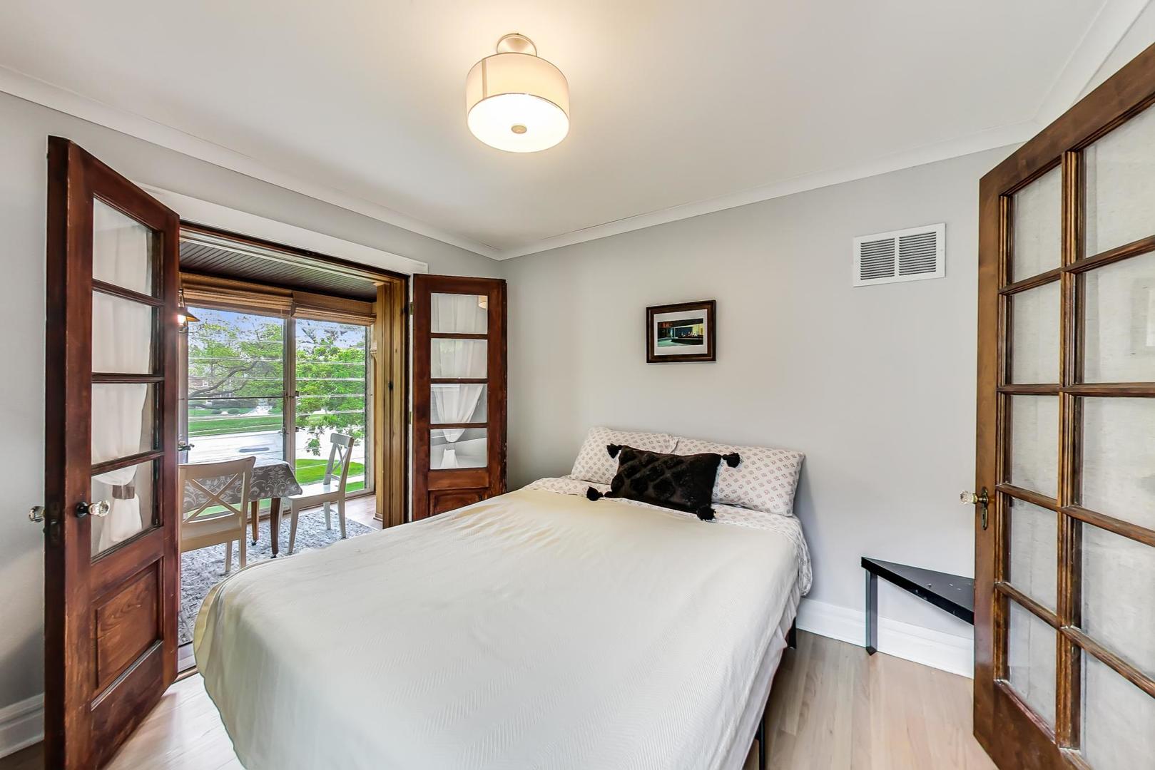 354 Longcommon Road Riverside, IL 60546 - Photo 14 of 37 a bedroom with a large bed and a large window