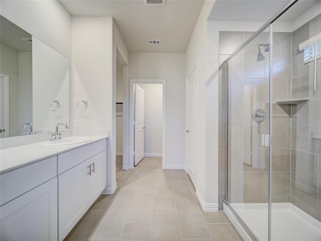 3405 Kingsgarden Road Denton, TX 76207 - Photo 13 of 37 a bathroom with a double vanity sink and mirror