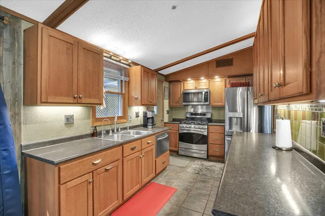 a kitchen with a sink stove and cabinets